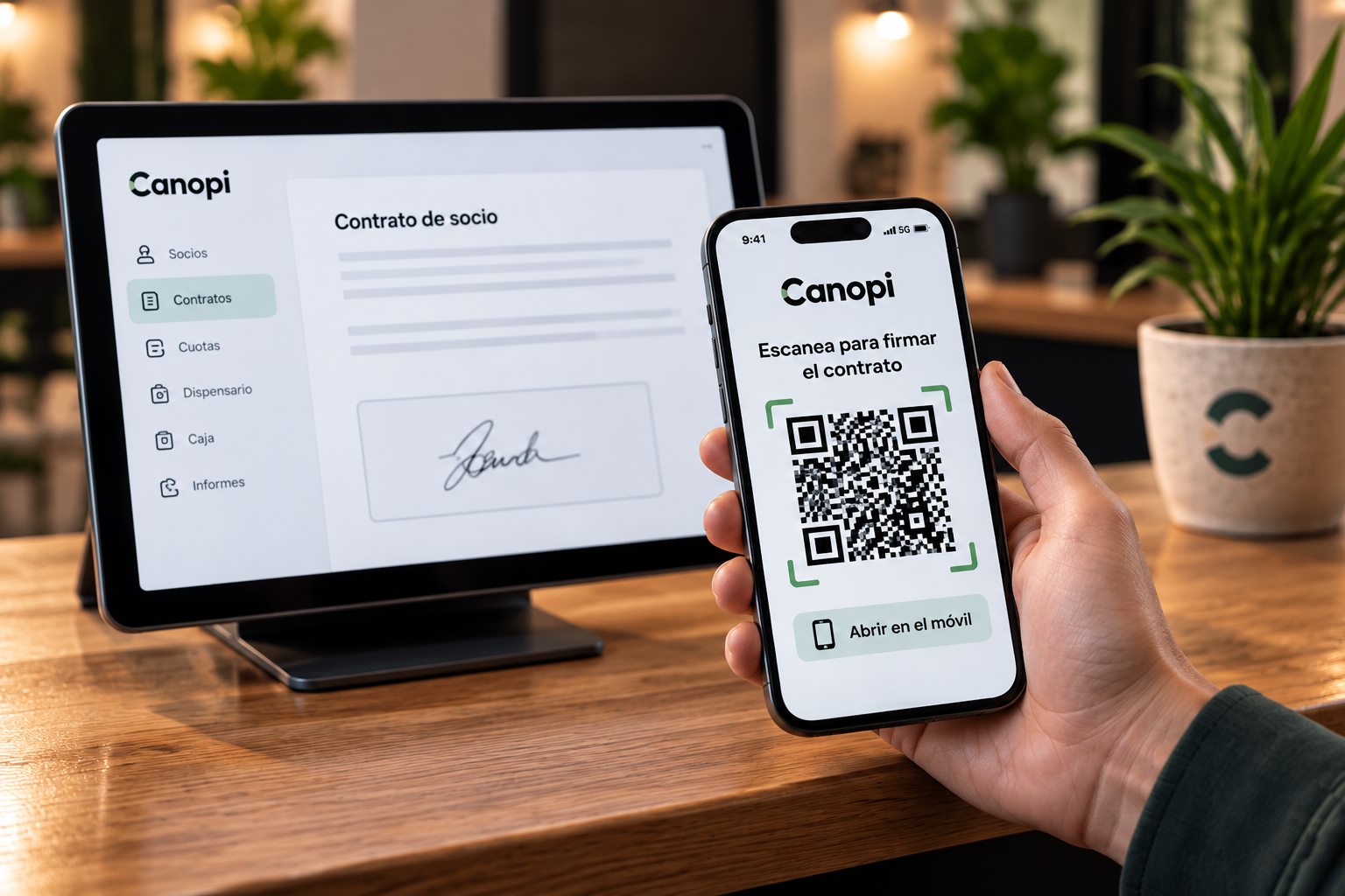 Tablet con el contrato de socio firmado en Canopi y un móvil con el código QR para firmar el contrato